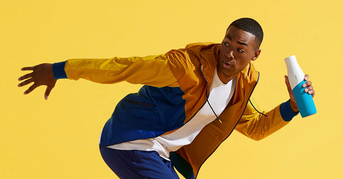 A young man holding a LARQ Bottle Movement PureVis